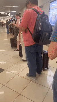 Passengers Sleep in Atlanta Airport Hallways Following Mass Cancellations