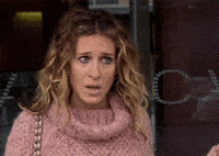 TV gif. Sarah Jessica Parker as Carrie on Sex and the City looks shocked and stunned as leans forward and her jaw drops. 