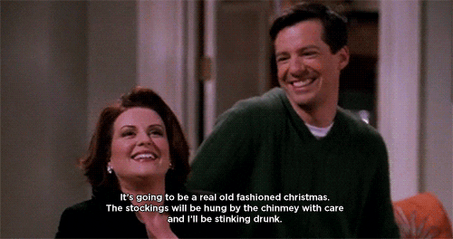 TV gif. Sean Hayes as Jack laughs while Megan Mullally as Karen says wistfully, “It’s going to be a real old-fashioned Christmas. The stockings will be hung by the chimney with care, and I’ll be stinking drunk.”