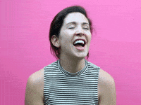 Video gif. Woman leans forward, smiling, as she says, "I know!" in an exasperated manner.