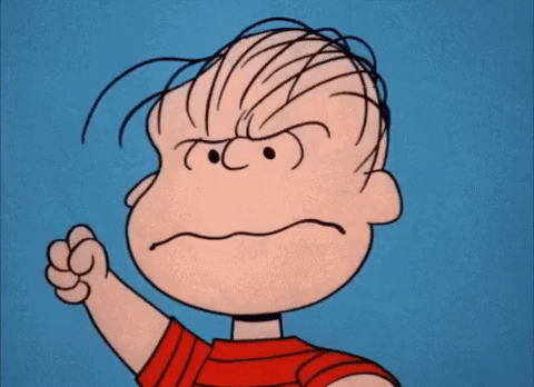 Peanuts gif. Linus furrows his brow and clenches his fists in anger showing clenched teeth.