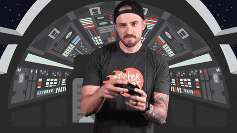 A man is holding a game controller and we see the word, "GAMING" in bold letters.