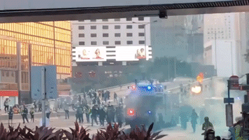 Hong Kong Police Truck Sprays Blue Dye as it Advances Toward Protesters