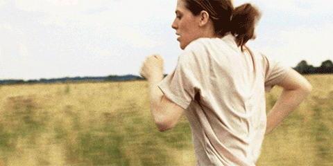 Movie gif. Honor Swinton Byrne as Julie in "The Souvenir" running through a tall grassy field.