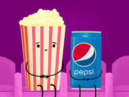 Ad gif. A bucket of popcorn and a can of Pepsi sit at a theater together. The popcorn looks nervous as they put their arm around the can of Pepsi, but as the Pepsi leans in, they smile.