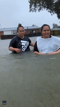 'Hey Brother, You Can't Park Here!' Kiwi Family in Good Spirits Wading Through Waist-High Water