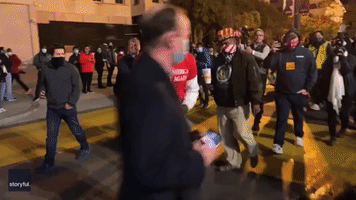 Man in MAGA Shirt Threatens Demonstrator Before DC Police Escort Him Away
