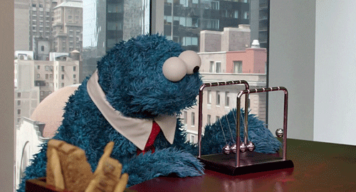 Muppets gif. Cookie Monster sits at a desk and sways his head in sync with a Newton's cradle as he watches it swing back and forth while one of his eyes wobbles.