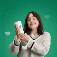 Sponsored gif. Woman smiles and cuddles a to-go cup of Starbucks coffee against her face. White hearts float up around her. Text reads, “Life saver.”