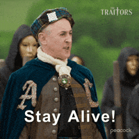Sponsored gif. Alan Cumming as host of The Traitors dressed in a plaid hat and a velvet cloak aggressively yells, “Stay alive!” Text also reads, “Stay alive!”