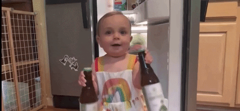 SNL gif. A toddler carries a beer bottle in each hand as she walks away from an open fridge, then topples over.