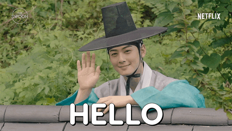 TV gif. Cha Eun-woo as Yi Rim in Rookie Historian Goo Hae-ryung leans on the edge of a fence, smiling and waving hello.