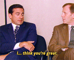 The Office gif. Steve Carrell as Michael Scott sits with his arms crossed, looking at Paul Lieberstein as Toby and shrugging as he says "I... think you're great" which appears as text.