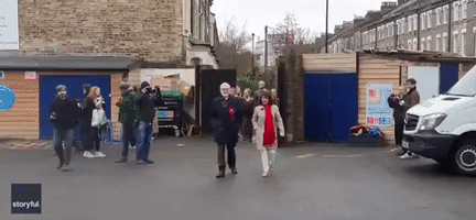 Labour Leader Jeremy Corbyn Met at Polling Station by Campaigner Dressed as Elmo