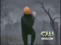 Video gif. Pumpkin Dance man in a black unitard with a jack-o-lantern on his head does dances from side-to-side in front of a graveyard backdrop. 