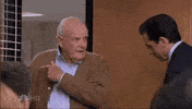 The Office gif. John Ingle as Robert Dunder speaks while Steve Carrell as Michael Scott nods and smiles and shuts him out of the conference room with the door.