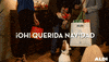 Ad gif. People hold Christmas gifts in a home entryway, and the middle person taunts a dog with a gift, making the dog jump up and down. Text, "Oh! Querida navidad."