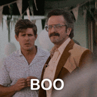 TV gif. Actors Marc Maron and Chris Lowell of GLOW in an outdoor scene. Marc Maron offers an impassioned "Boo!"