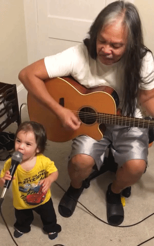 Toddler Sings Along as Grandad Plays Guitar