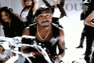 Celebrity gif. Tupac Shakur shrugs, raising his hands as if to say, “I have no idea.”