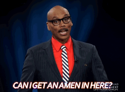 Reality TV gif. RuPaul, wearing a dark pinstripe suit over a red shirt, cocks his head and looks around. From under his mustache, he says, "Can I get an amen in here?" which also appears as text.