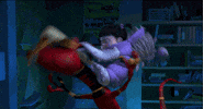 Disney gif. Boo in Monsters, Inc. jumps on a monster, hitting him with a baseball bat. Every time she hits him, he changes colors.