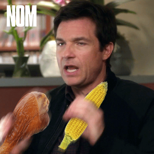 Movie gif. Jason Bateman as Nick in Horrible Bosses 2. He's been edited to hold a turkey leg and a corn on the cob in both hands as he moves it up and down. Text, "Nom nom nom."