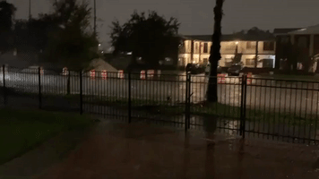 Car Drives Along Flooded Street as Tropical Storm Eta Hits Tampa
