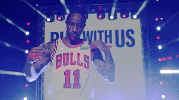 Video gif. Promo video featuring Demar DeRozan of the Chicago Bulls on a stage wearing his basketball jersey. He looks at us and points at his jersey number. A banner in the background says, "Run with us."