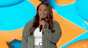 Video gif. A young female presenter on the 2024 Summer Game Fest stage looks amused. She giggles as she says, "Sounds like you did." as the caption at the bottom of the gif reads.