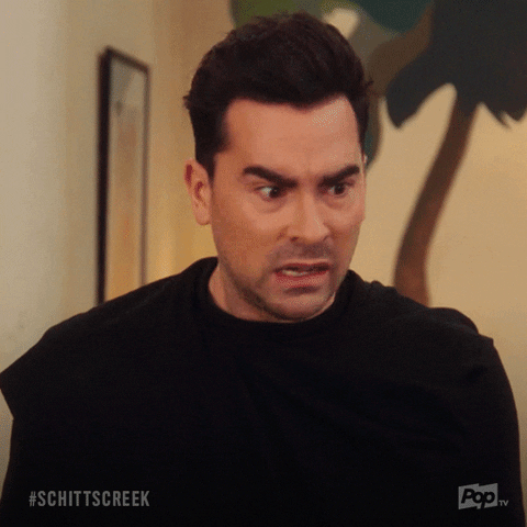 Schitt's Creek gif. Dan Levy as David shakes in a panic as he shouts to bottom right of frame. Text, "Oh my god."