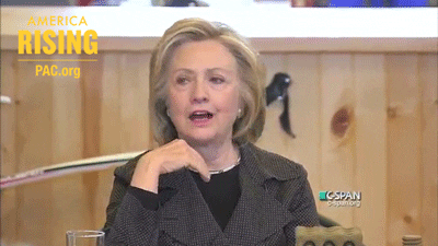 Political gif. Hilary Clinton reacts with delighted surprise on C-SPAN next to a logo for America Rising PAC.org.