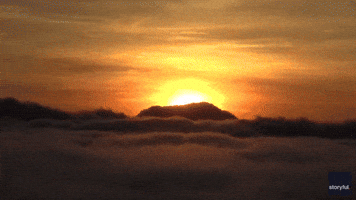 Dream-Like Scene Captured in Indonesia as Sun Rises Over Thick Clouds