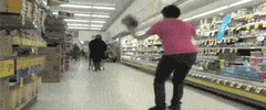 Video gif. Man slips sideways onto the floor from a liquid spill at a grocery store, sped up comically as he falls before freeze-framing on his sprawled form and text appearing reading, "Dead."