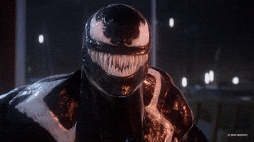 Video game gif. A recreation of the Jack Nicholson nodding meme featuring Venom from the Playstation video game "Spider-Man 2." Venom mimics Nicholson in the meme and devilishly nods and smiles, revealing a row of spiky, monstrous white fangs. Venom's white wing-shaped eyes, stark against his gooey black exterior, open and close as he nods. 