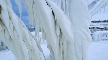 Storm Leaves Michigan Lighthouse and Pier Covered in Ice