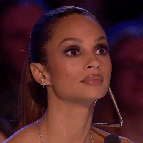 Reality TV gif. Close up on Alesha Dixon on Britain's Got Talent. She looks around with wide eyes, scared and confused at what will happen next.