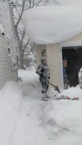 Woman With Shovel vs. Rooftop Full of Snow