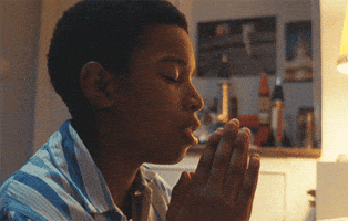 Movie gif. Kenyah Sandy as Kingsley in Small Axe Education with his palms together in prayer.