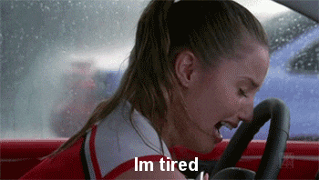 Video gif. A woman hangs her head over the steering wheel in her car and cries. Text, “I'm tired.”