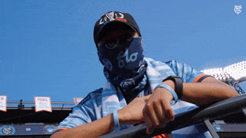NYCFC fan showing off the badge 
