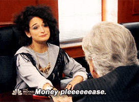 Parks and Recreation gif. Jenny Slate as Mona Lisa Saperstein holds her hand out across a conference table as she says, “money pleeeease.” Henry Winkler as Dr. Saperstein grabs her hands and amazingly slaps some cash into her hand. 