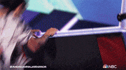 Reality TV gif. A contestant from American Ninja Warrior makes it up the final wall and roars with happiness. He cheers and jumps and celebrates his win. 