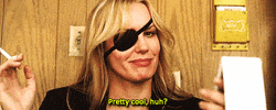 Movie gif. Daryl Hannah as Elle Driver in Kill Bill whispers to us while holding a cigarette, "Pretty cool, huh?"
