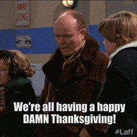 TV gif. Kurtwood Smith as Red Forman, Debra Jo Rupp as Kitty Forman, and Topher Grace as Eric Forman on That 70s Show stand outside  in heavy coats. Kitty shivers as Red angrily yells to Eric, “We're all having a happy damn Thanksgiving!” 