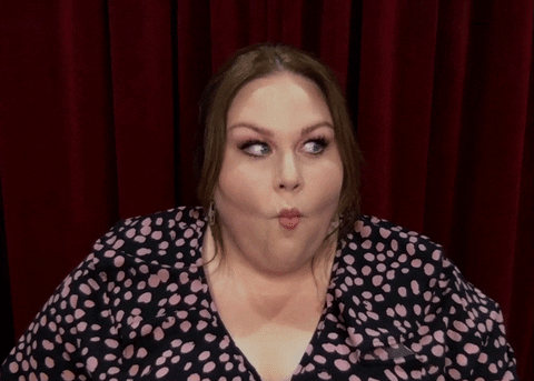 The Tonight Show gif. Chrissy Metz rolls her shoulders and her eyes from side as she does fish lips with her eyebrows raised.