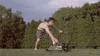 Video gif. A shirtless man in a field tries unsuccessfully to recoil start a lawn mower, violently pulling at the cord to try and get the engine to catch. This happens over and over again, never stopping. He'll never start that damn mower.