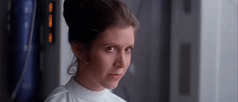 Movie gif. Carrie Fisher, as Princess Leia in Star Wars, reacts with a demure, pleased smile.