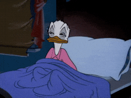 Disney gif. Donald Duck pulls a blue blanket over his head and snuggles into bed.