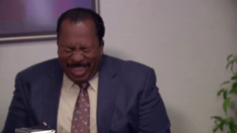 The Office gif. Leslie David Baker as Stanley closes his eyes as he buckles over in uncontrollable laughter.